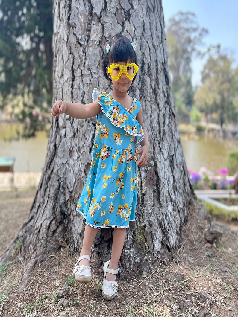 Model wearing blue floral knee length dress